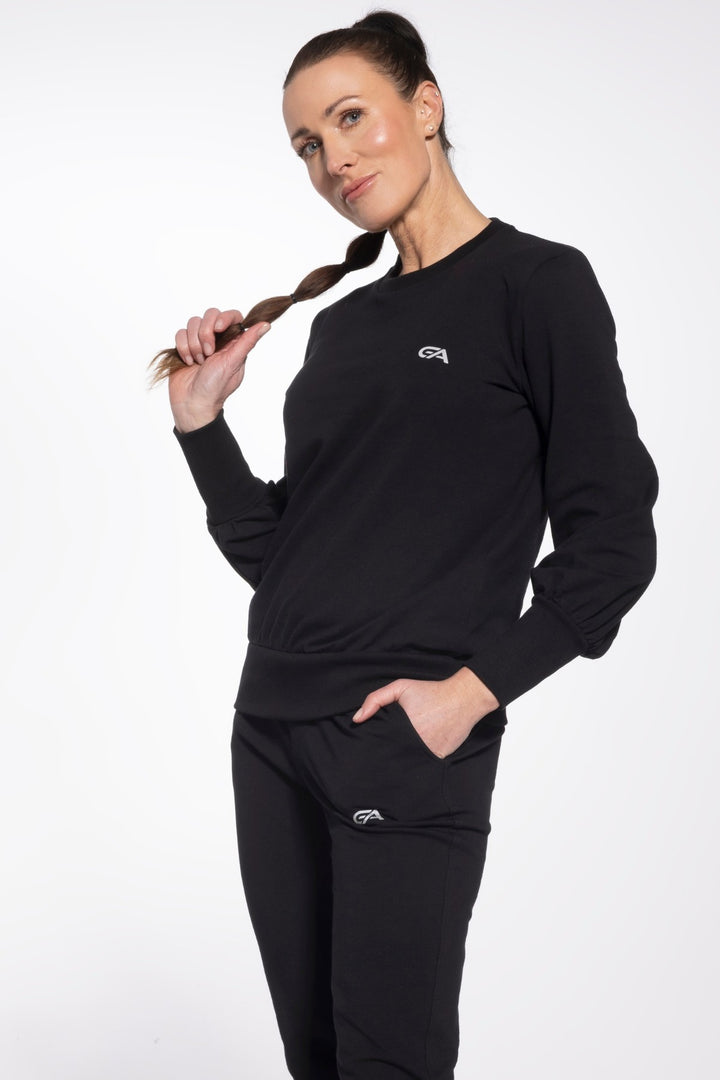 Woman wearing a black outfit with a logo on a white background