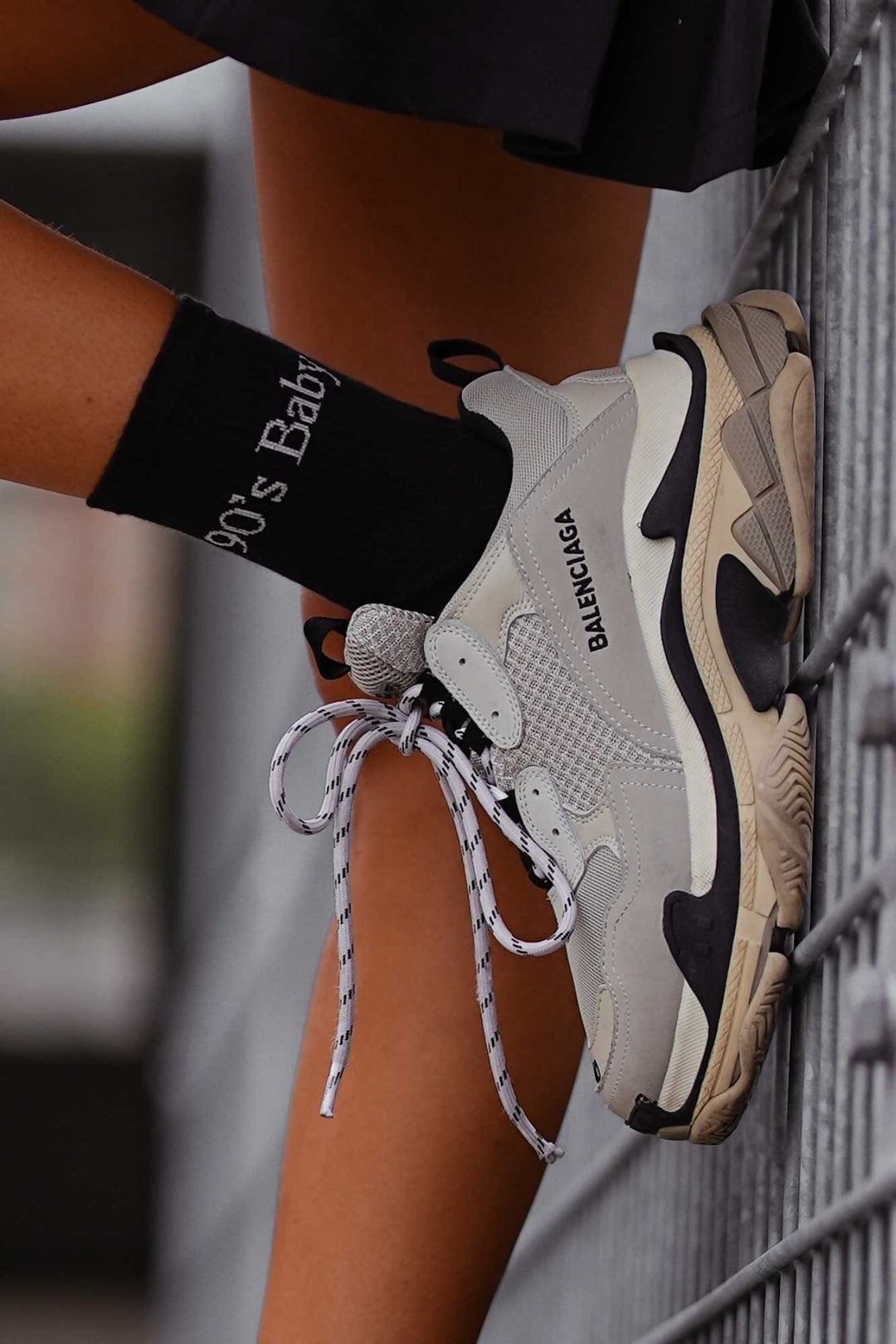 Close-up of black cotton socks with "90's Baby" slogan – bold lettering on soft breathable fabric
