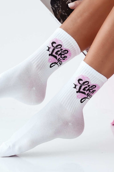 Close-up of white cotton socks with "I Like You" slogan – bold lettering on soft fabric
