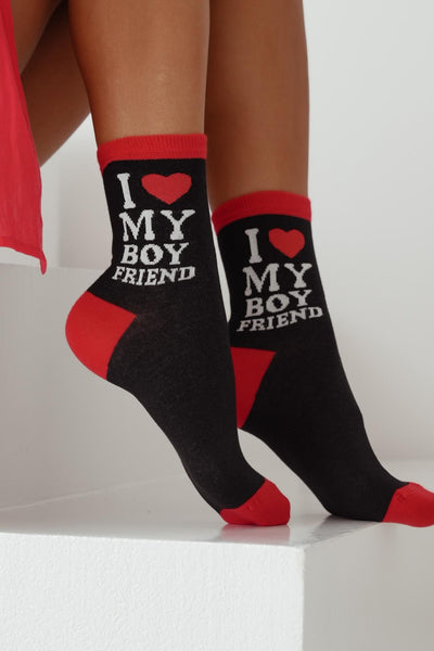 Close-up of black cotton socks with "I Love My Boyfriend" slogan – bold lettering on soft fabric
