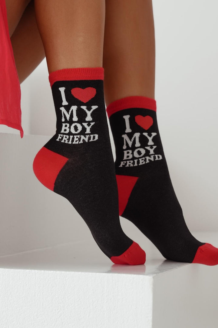 Close-up of black cotton socks with "I Love My Boyfriend" slogan – bold lettering on soft fabric
