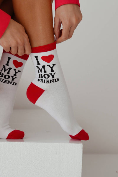 Close-up of white cotton socks with "I Love My Boyfriend" slogan – bold lettering on soft fabric
