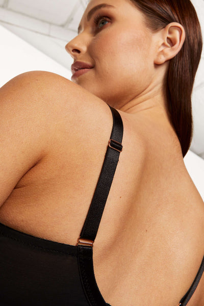Close-up of the Kala bra's black adjustable strap and rose-gold slider over the shoulder.
