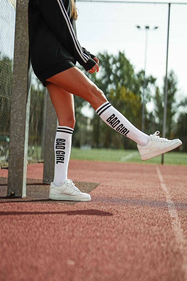 White and black "Bad Girl" cotton knee socks – third angle showing full length and print placement
