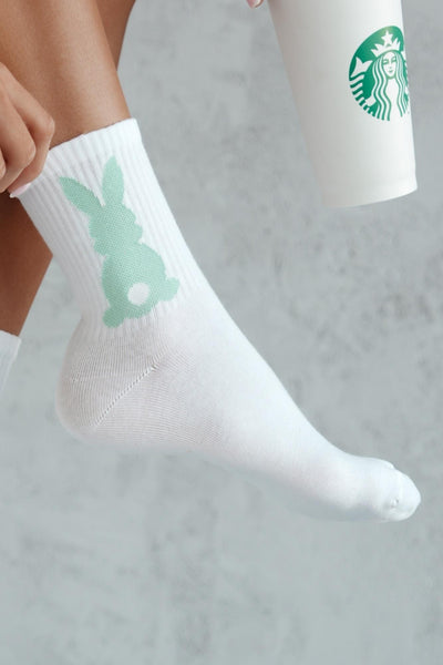 Close-up of mint cotton socks with bunny tail – fluffy tail detail on soft breathable fabric
