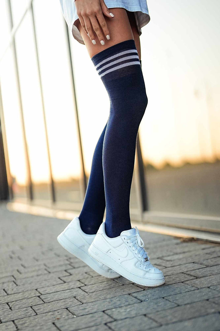 Dark navy cotton over-knee socks with striped welt – side view showing stripe detail and full length
