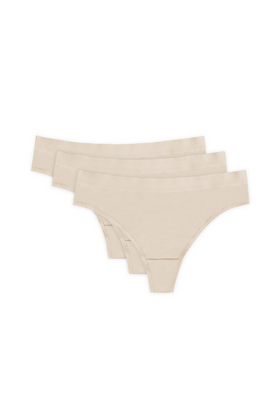 Alana cotton thong triple pack in beige: three thongs shown flat with covered waistbands.
