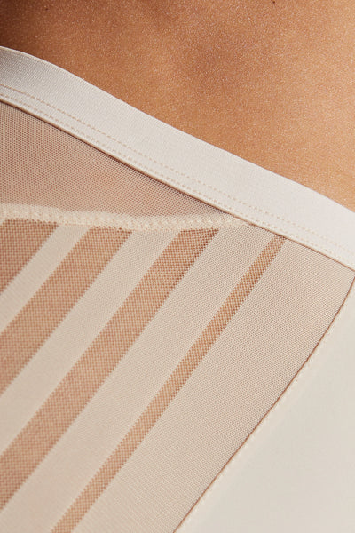 Close-up of the Luna panty's sheer diagonal stripes below its wide flat waistband.