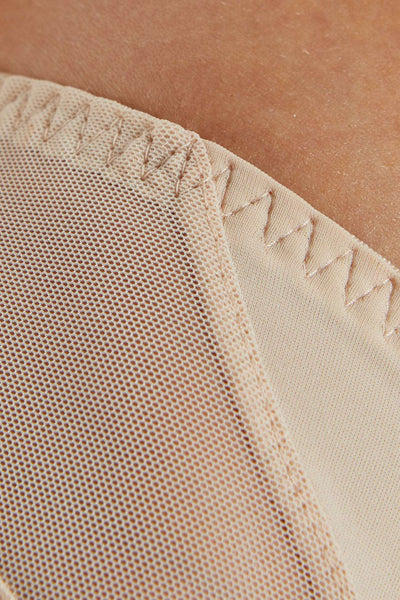 Close-up of the Zara beige panty's mesh side panel and zigzag-stitched edge.