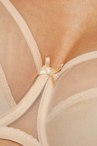 Close-up of the Zara beige bra's centre bow where the tulle meets the smooth jersey cup.