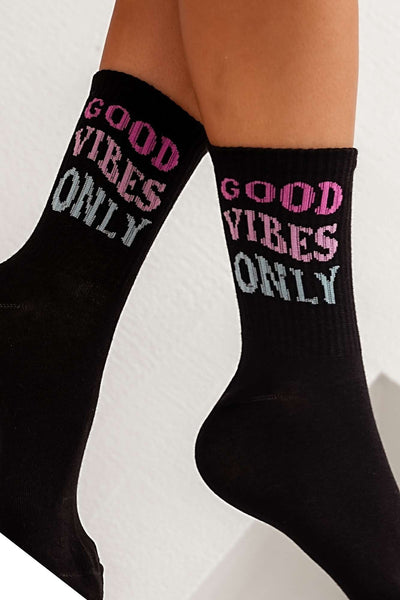 Close-up of black cotton socks with "Good Vibes Only" slogan – bold lettering on soft fabric

