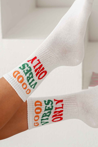 White cotton socks with "Good Vibes Only" text print – side view showing slogan and ankle fit
