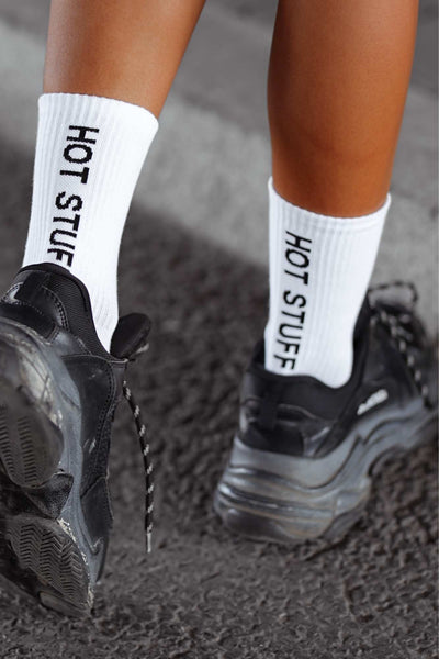 Close-up of white cotton socks with "Hot Stuff" slogan – bold lettering on soft breathable fabric

