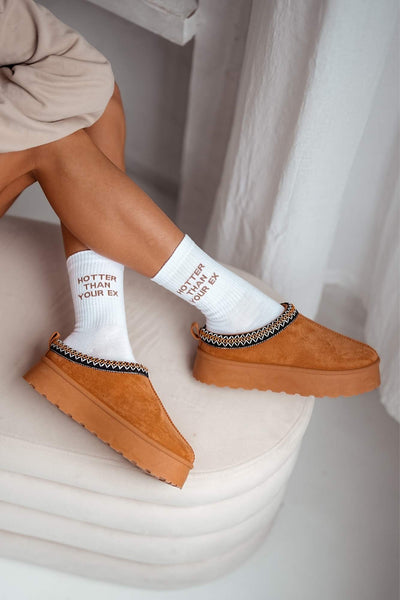 White "Hotter Than Your Ex" cotton socks styled with UGG shoes – side view showing slogan and fit
