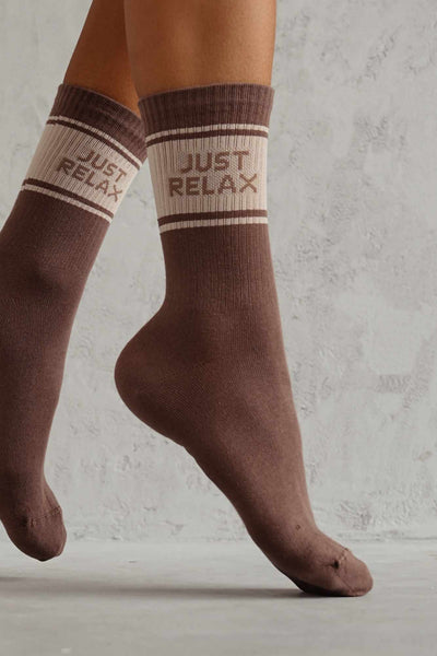 Close-up of cappuccino cotton socks with "Just Relax" slogan – bold lettering on soft fabric
