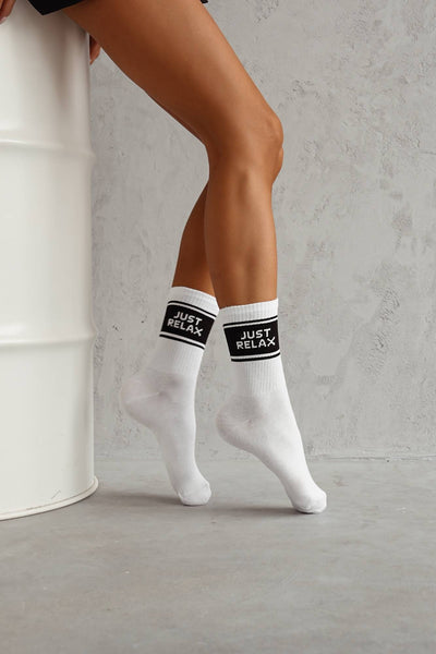 White cotton socks with "Just Relax" text print – side view showing slogan and ankle fit
