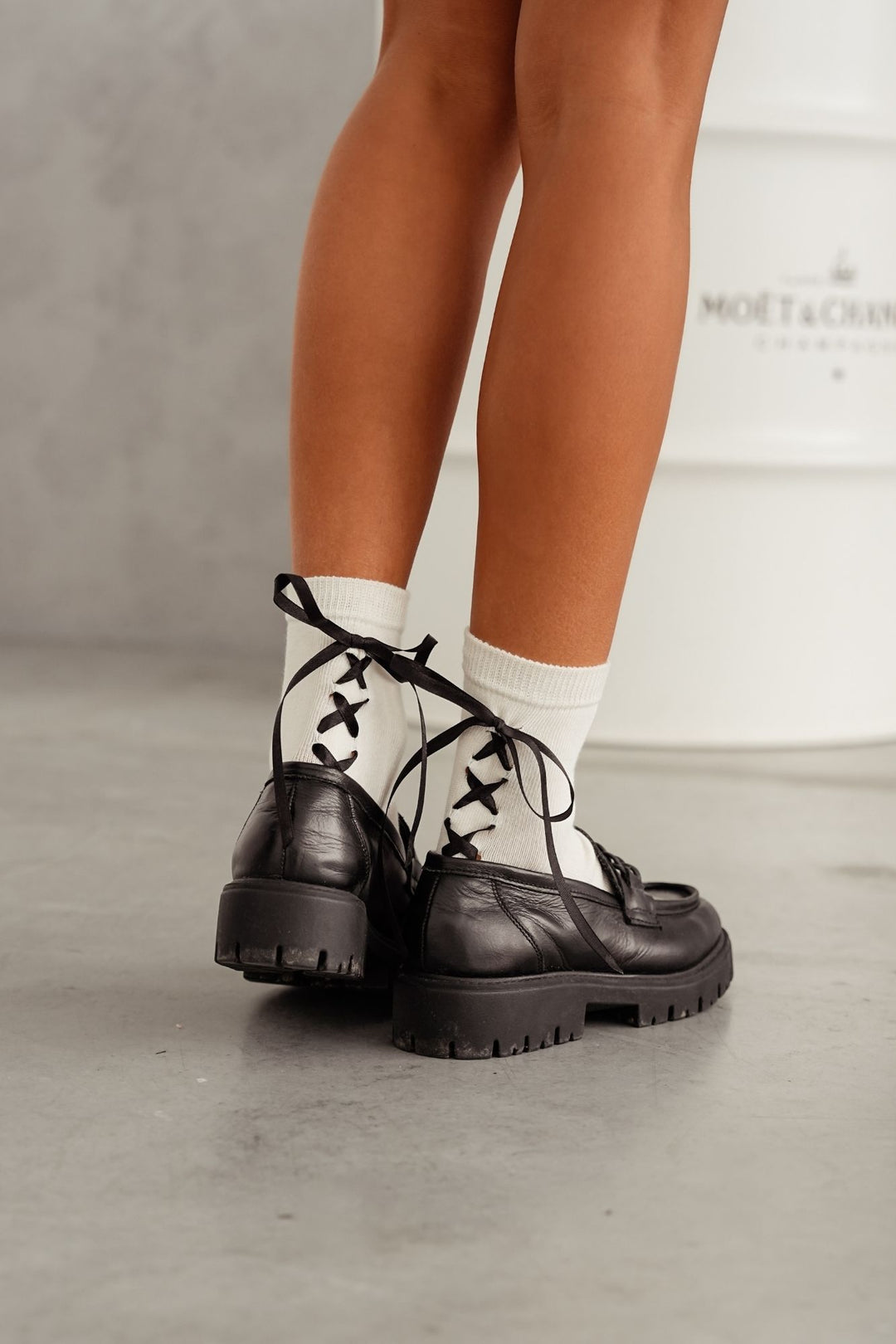 Ecru lace-trim cotton socks styled with shoes – back view showing ribbon heel and lace edge
