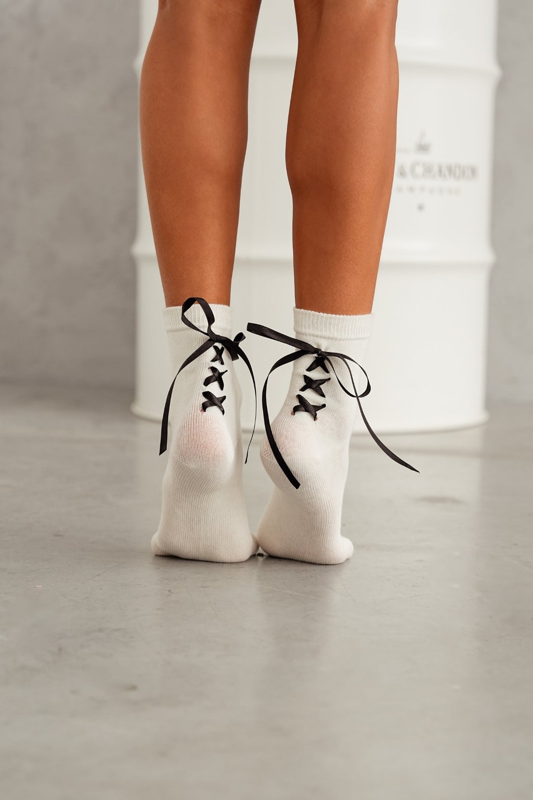 Ecru lace-trim cotton socks styled with shoes – side view showing ribbon heel and lace edge
