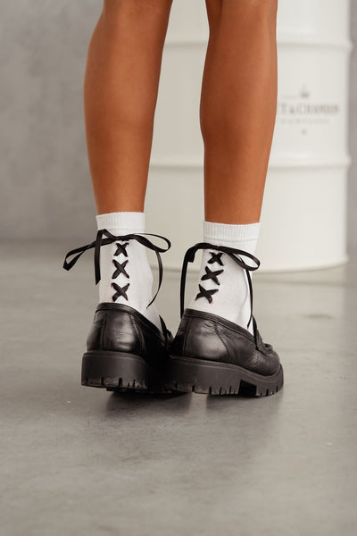 White lace-trim cotton socks styled with shoes – back view showing ribbon heel and lace edge
