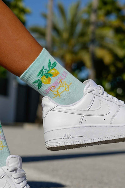Close-up of mint green Limoncello cotton socks – lettering detail on soft breathable fabric
