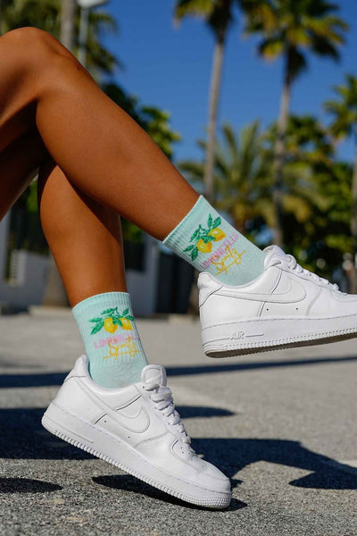 Mint green cotton socks with Limoncello text print – side view showing pattern and ankle fit
