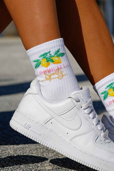 Close-up of white Limoncello cotton socks – lettering detail on soft breathable fabric
