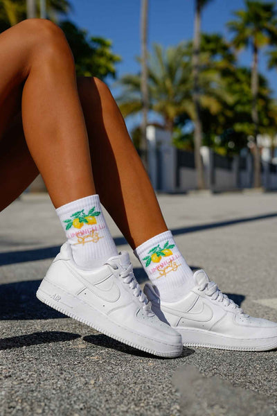 White cotton socks with Limoncello text print – side view showing pattern and ankle fit
