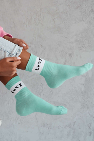 Mint cotton socks with "Love" text print – side view showing slogan and ankle fit
