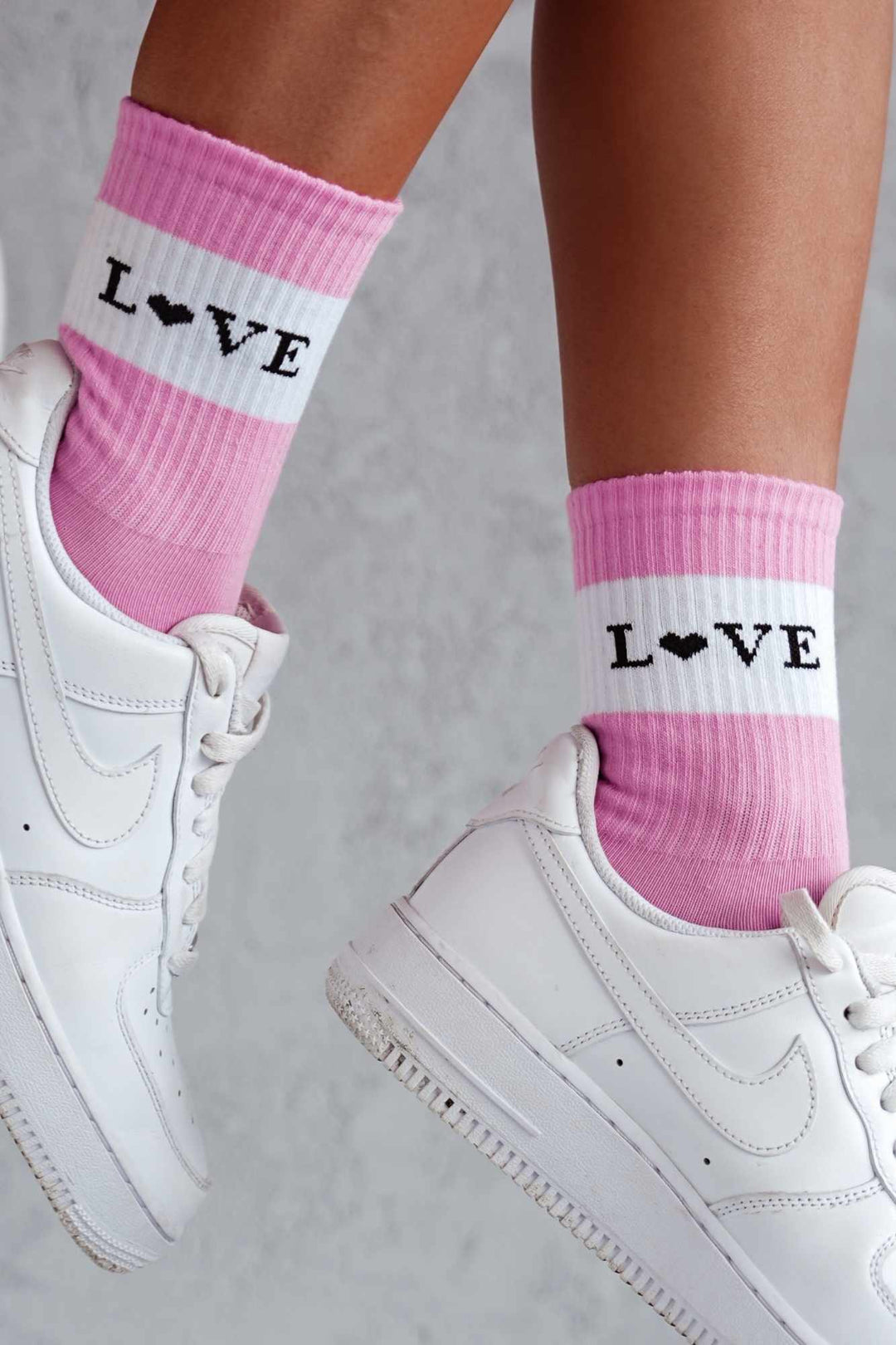 Close-up of pink cotton socks with "Love" slogan – bold lettering on soft breathable fabric
