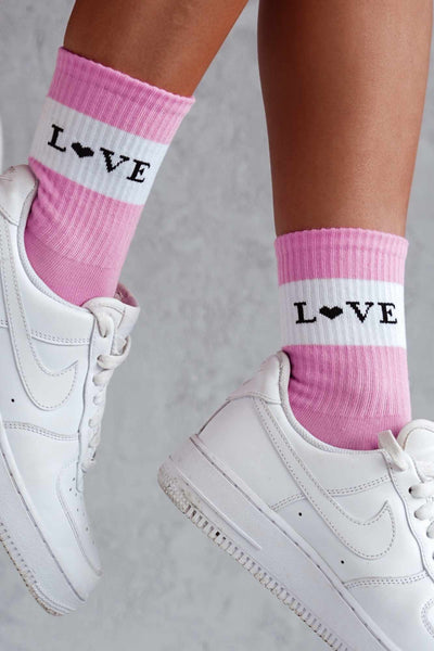 Close-up of pink cotton socks with "Love" slogan – bold lettering on soft breathable fabric
