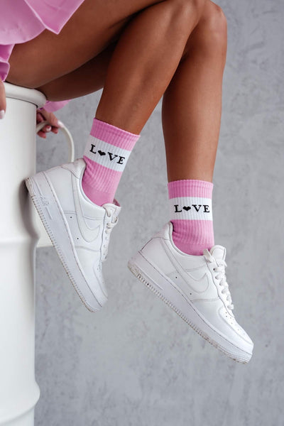 Pink cotton socks with "Love" text print – side view showing slogan and ankle fit
