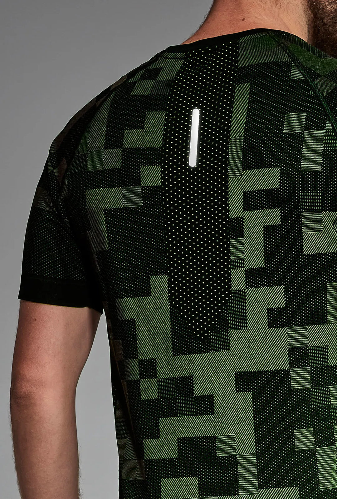 Black green training T-shirt back close-up, fabric and seam detail
