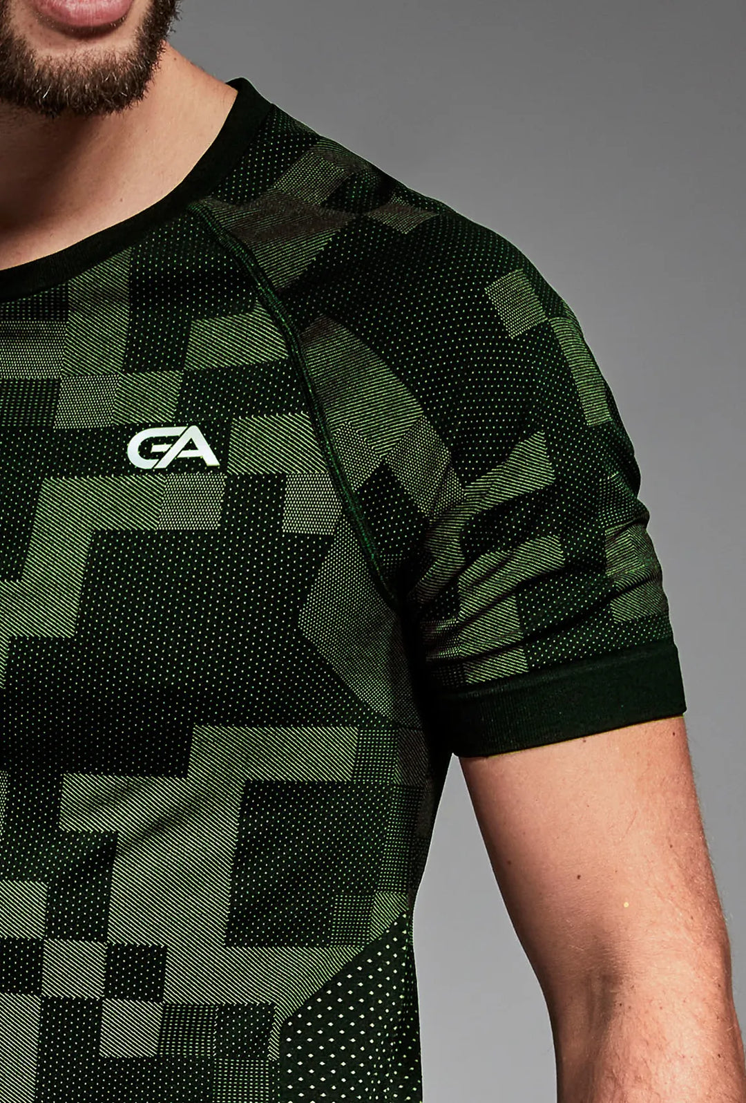 Black green gym T-shirt front close-up, reflective detail visible
