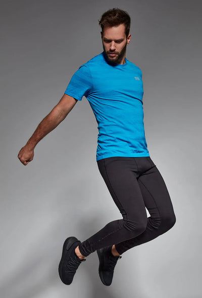 Ziggy active sports t-shirt in blue marl, worn mid-jump with black training leggings.