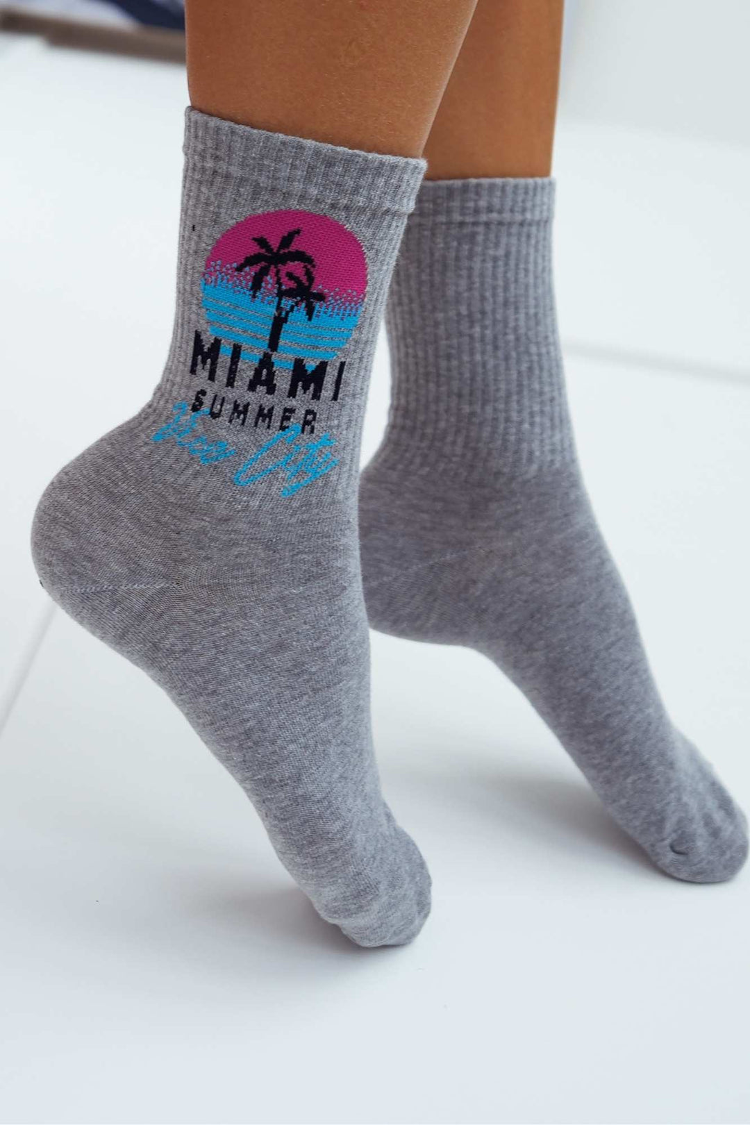 Close-up of light melange Miami Vice City cotton socks – retro print detail on soft fabric
