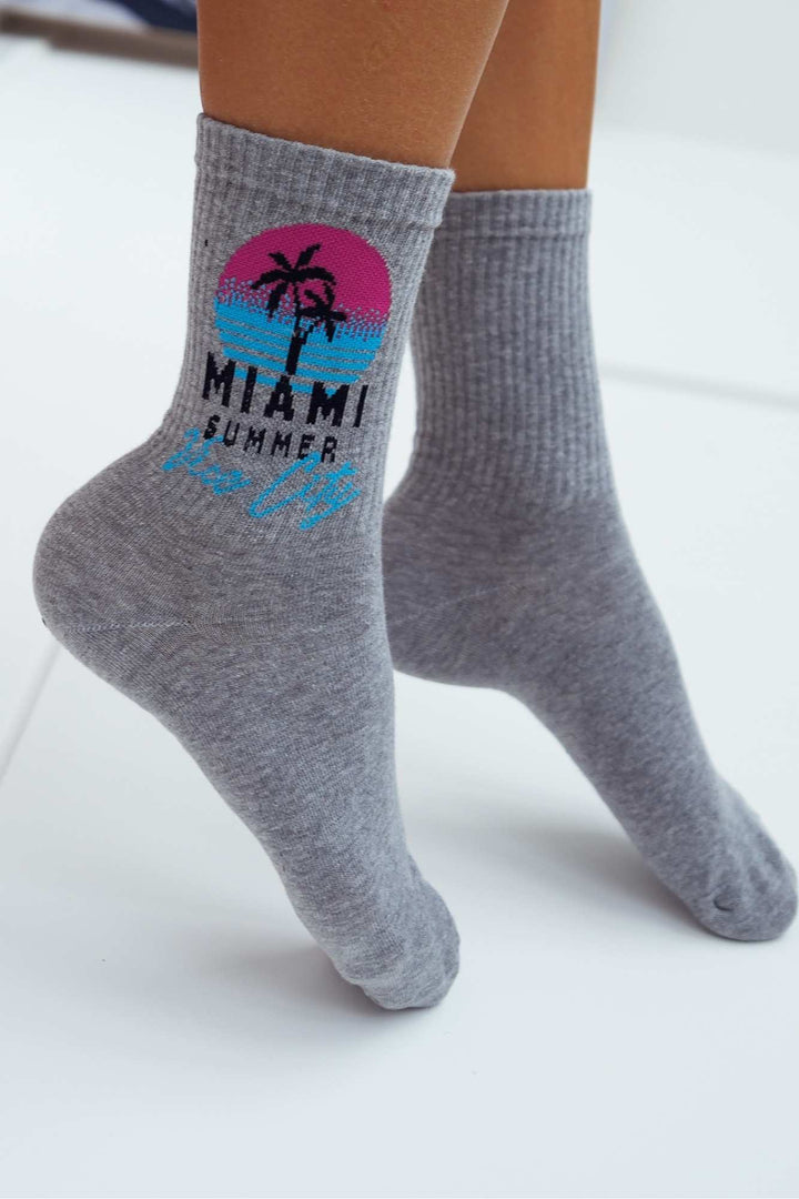 Close-up of light melange Miami Vice City cotton socks – retro print detail on soft fabric
