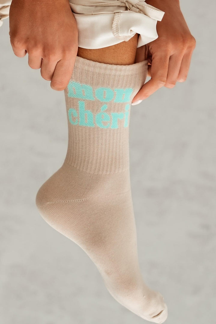 Close-up of beige Mon Chéri cotton socks – lettering detail on soft breathable fabric
