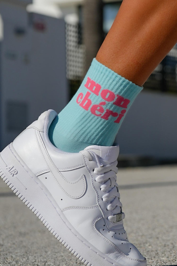 Close-up of light blue Mon Chéri cotton socks – lettering detail on soft breathable fabric
