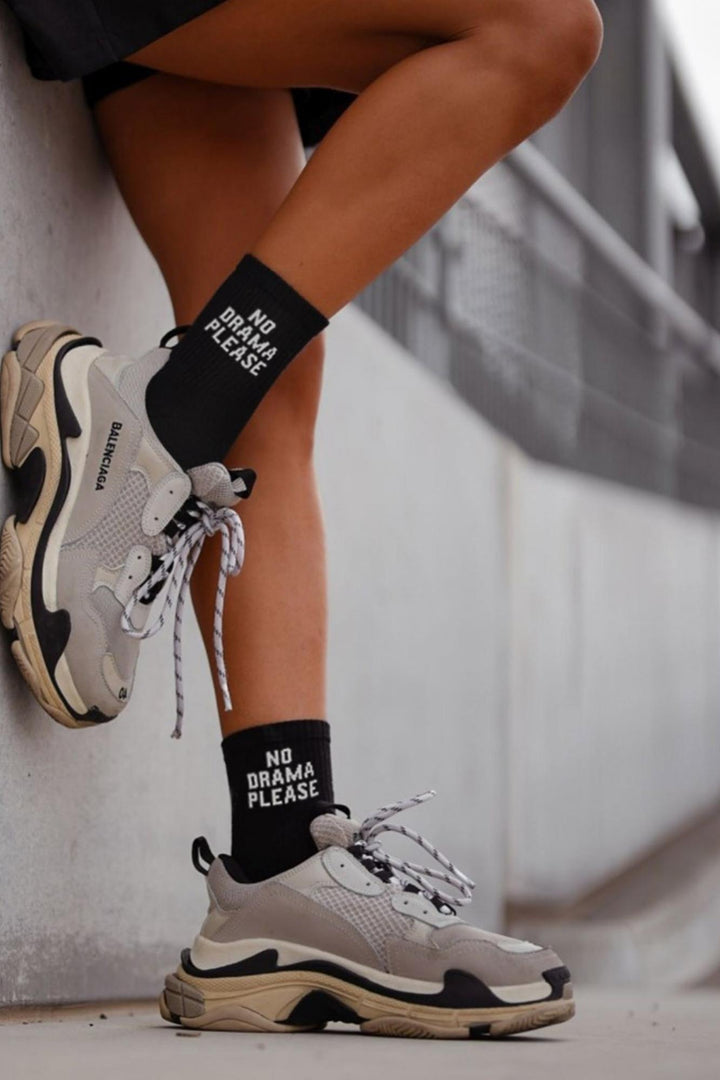 Black cotton socks with "No Drama Please" text print – side view showing slogan and ankle fit
