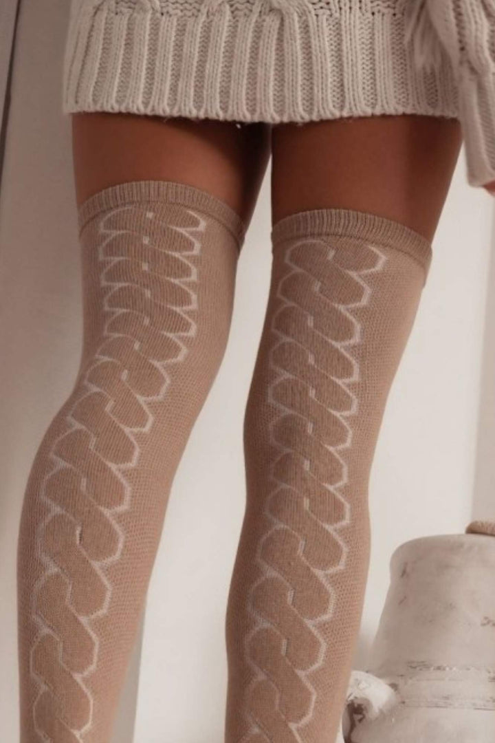 Close-up of beige openwork over-knee socks – delicate back braid pattern on soft breathable fabric
