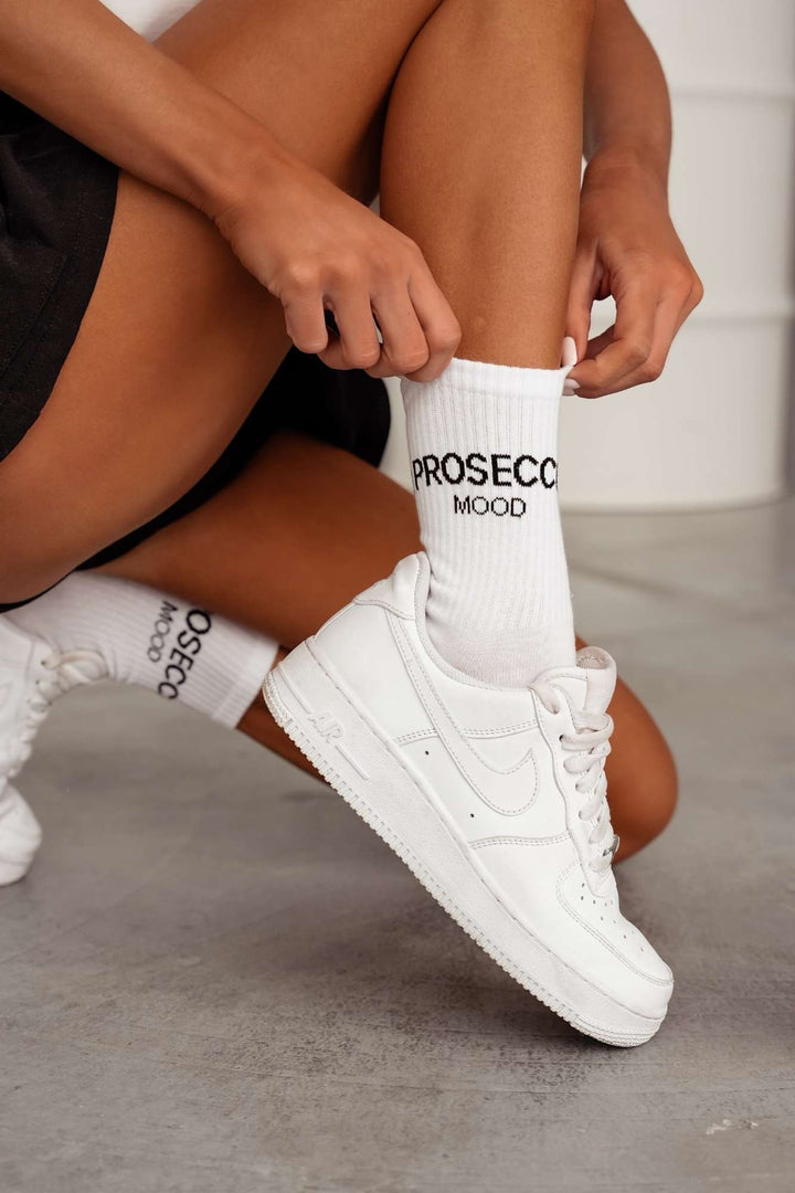 White and black cotton socks with Prosecco Mood text print – side view showing pattern and fit
