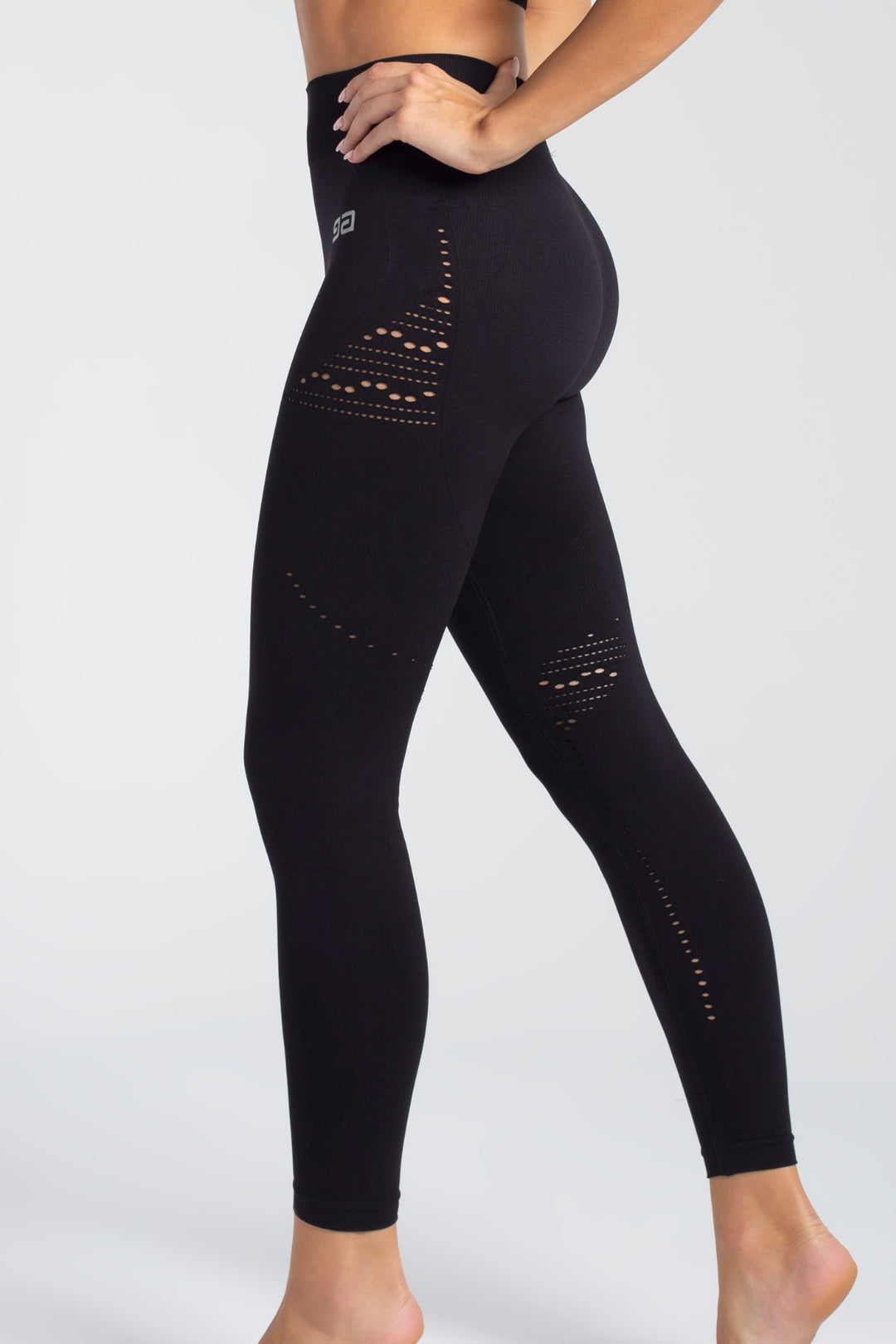 Black activewear leggings side profile, slim silhouette
