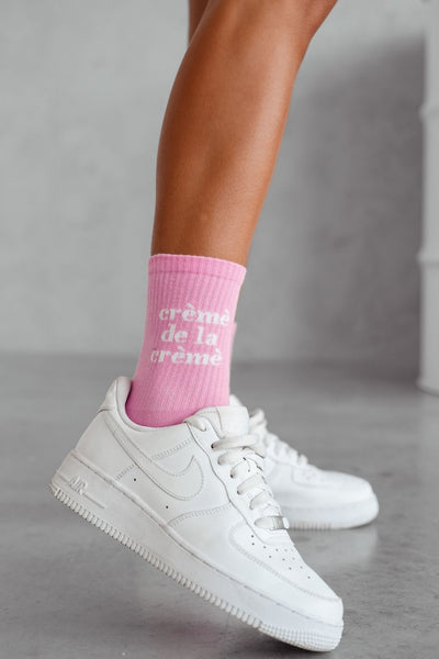 Pink Crème de la Crème cotton socks – second side angle showing text print and sock length

