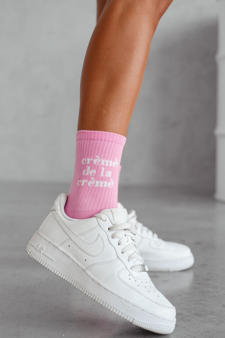 Pink Crème de la Crème cotton socks – second side angle showing text print and sock length
