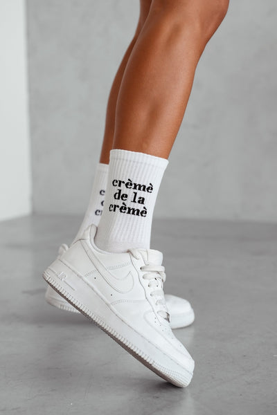 White cotton socks with Crème de la Crème text print – side view showing pattern and fit
