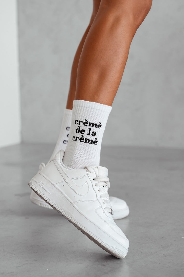 White cotton socks with Crème de la Crème text print – side view showing pattern and fit
