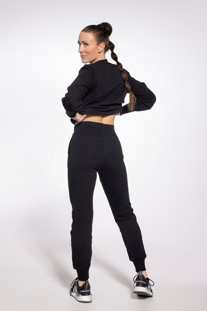 Woman wearing a black outfit on a white background
