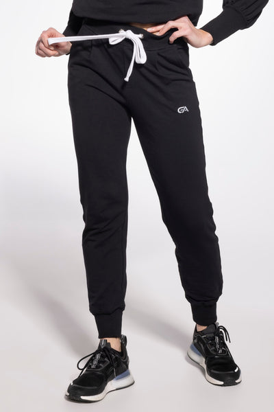 Gatta cotton sweatpants in black, front view as the model pulls the white drawstring.