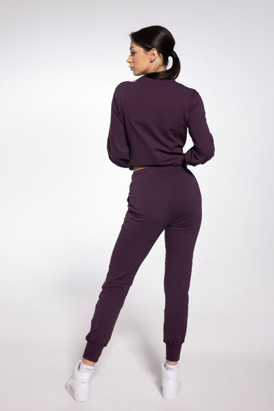 Gatta plum purple sweatpants and sweatshirt seen from behind, full-length with trainers.