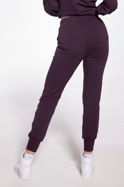 Gatta plum purple sweatpants from behind, showing the elastic waist and ribbed ankle cuffs.